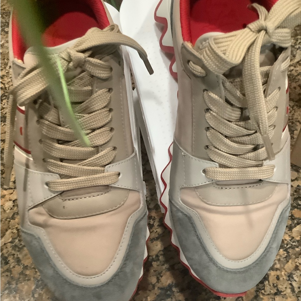 Stylish Beige and Gray Sneakers with Red Accents